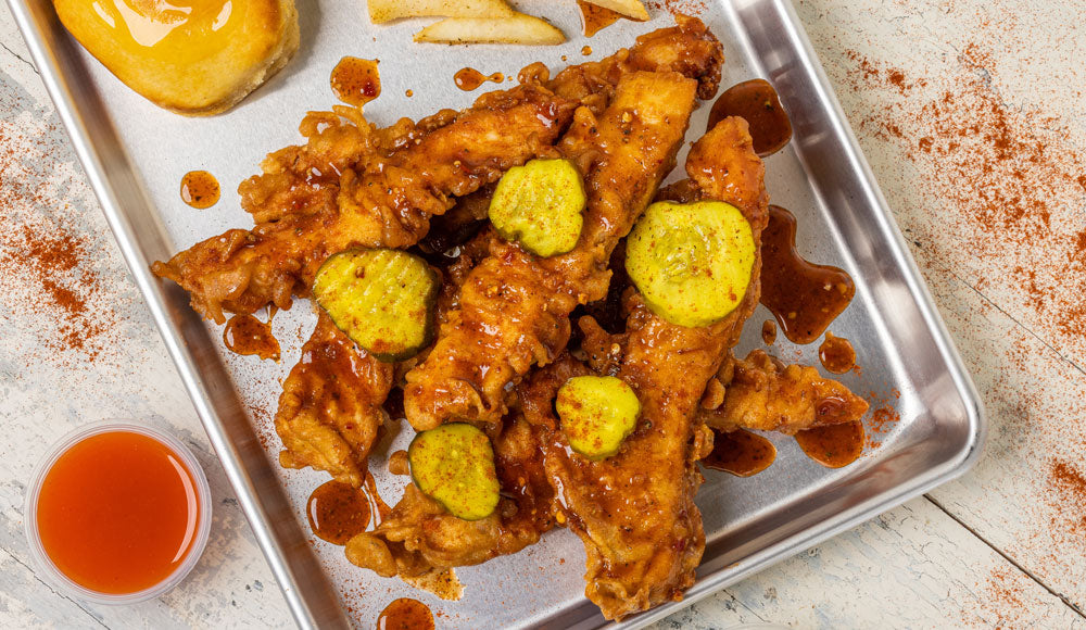 Jumbo kettle-fried chicken strips, alongside kettle fries, buttermilk biscuit, and sweet ‘n’ tangy pickles.